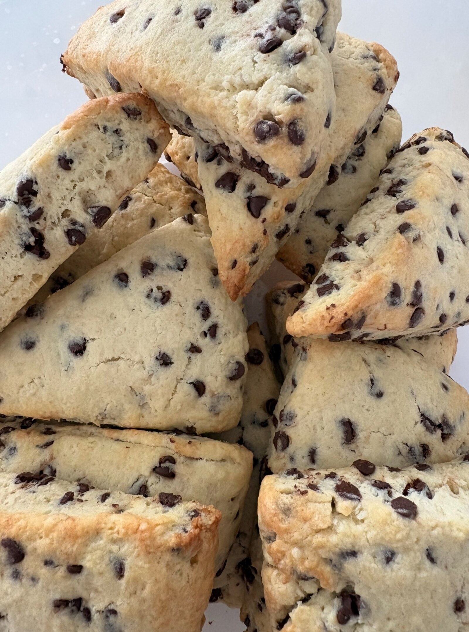Golden gourmet scones with fresh blueberries on cream linen